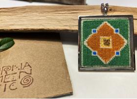Handmade embroidered pendant in a silver frame (type 21)